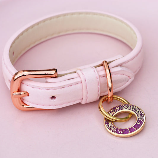 Hoop-shaped brass ID tag with engraved Celtic pattern, handmade in the UK. Suitable for dogs, cats, and horse bridles. Shown attached to a collar for display.