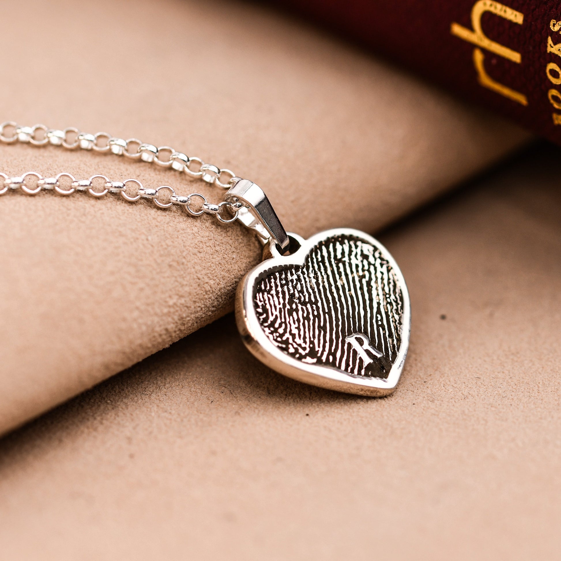 Artisan fingerprint heart necklace in sterling silver, engraved with a full fingerprint and a small initial, on a rolo chain