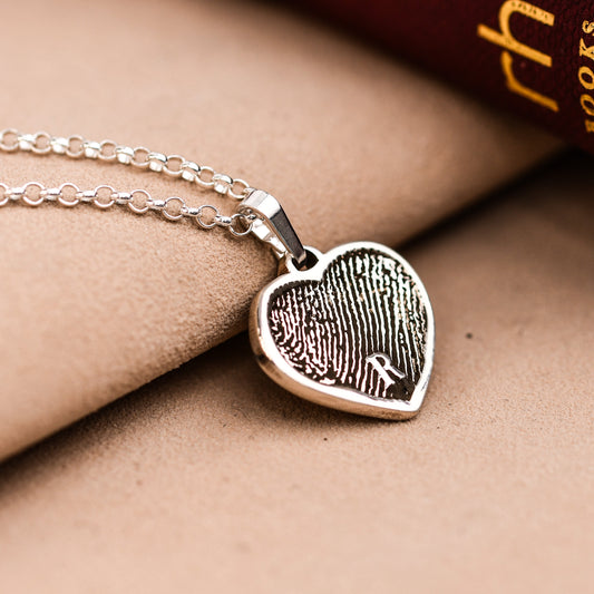 Artisan fingerprint heart necklace in sterling silver, engraved with a full fingerprint and a small initial, on a rolo chain