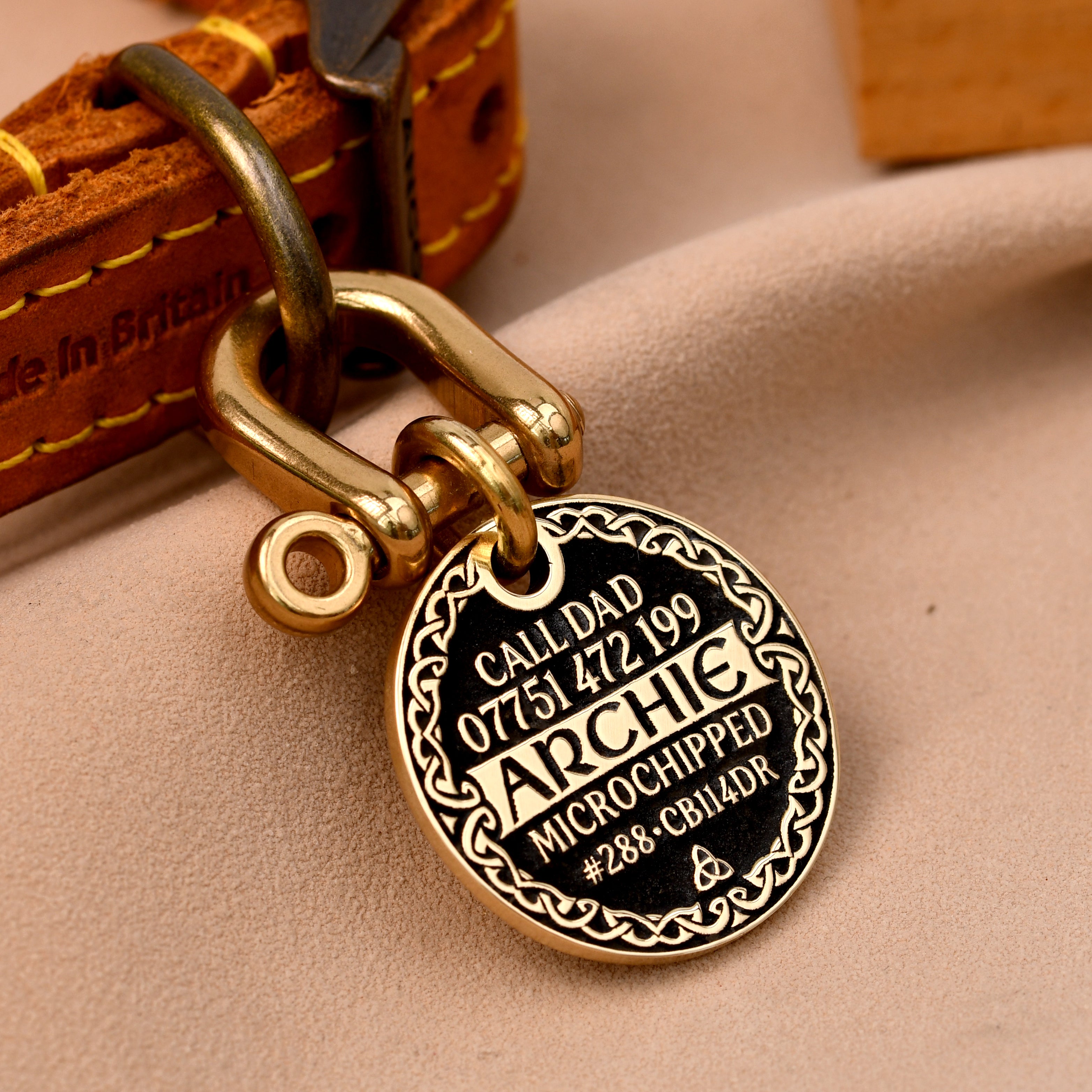 Celtic border brass dog tag with full engraving, name Archie, in black with Celtic knot pattern frame