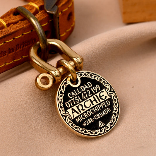 Celtic border brass dog tag with full engraving, name Archie, in black with Celtic knot pattern frame