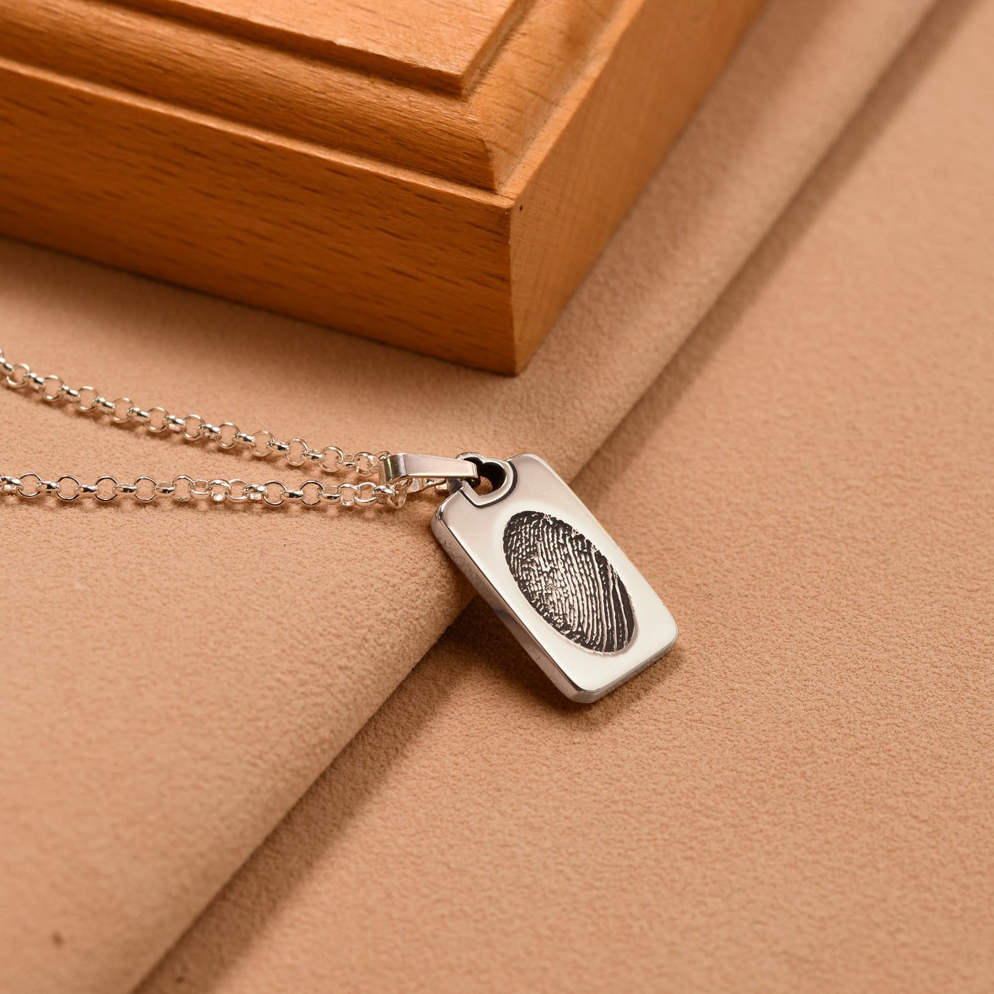 Fingerprint dog tag necklace with a full fingerprint engraved across the face