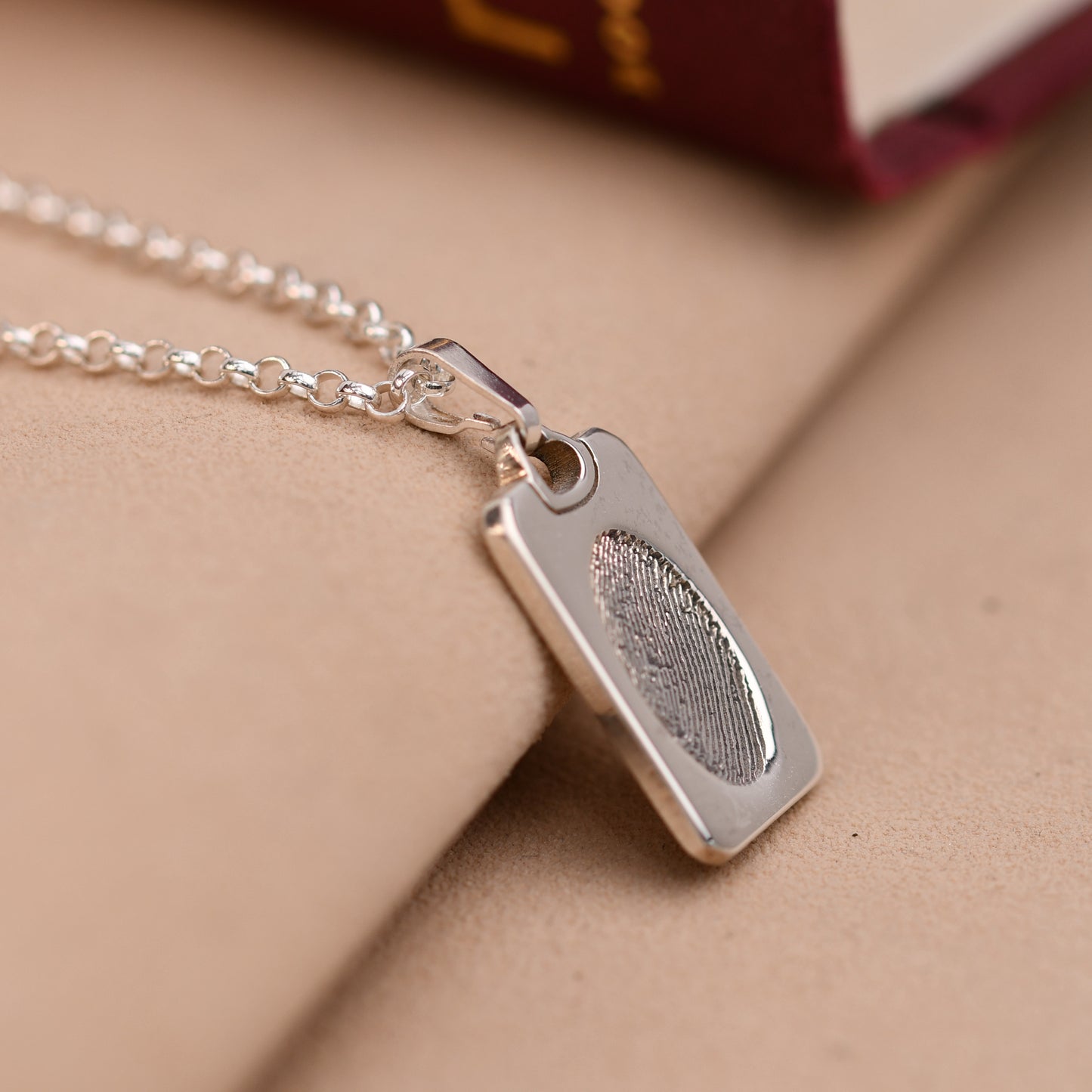 Fingerprint dog tag necklace with a full fingerprint and an initial set in a heart
