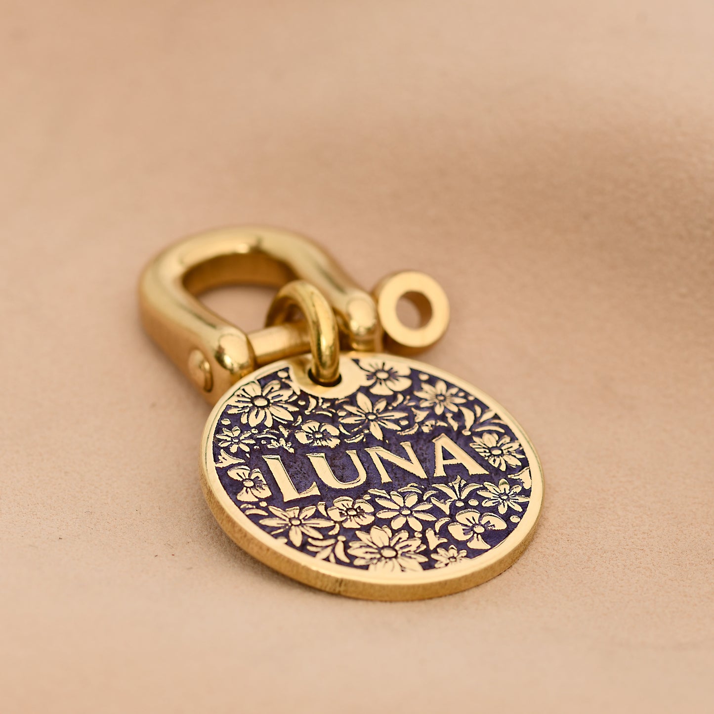 Floral brass dog tag with one-word engraving Luna in purple surrounded by flower pattern