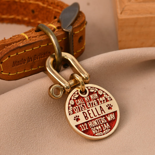 Floral brass dog tag with full engraving — name Bella, phone, address — and flower border in red