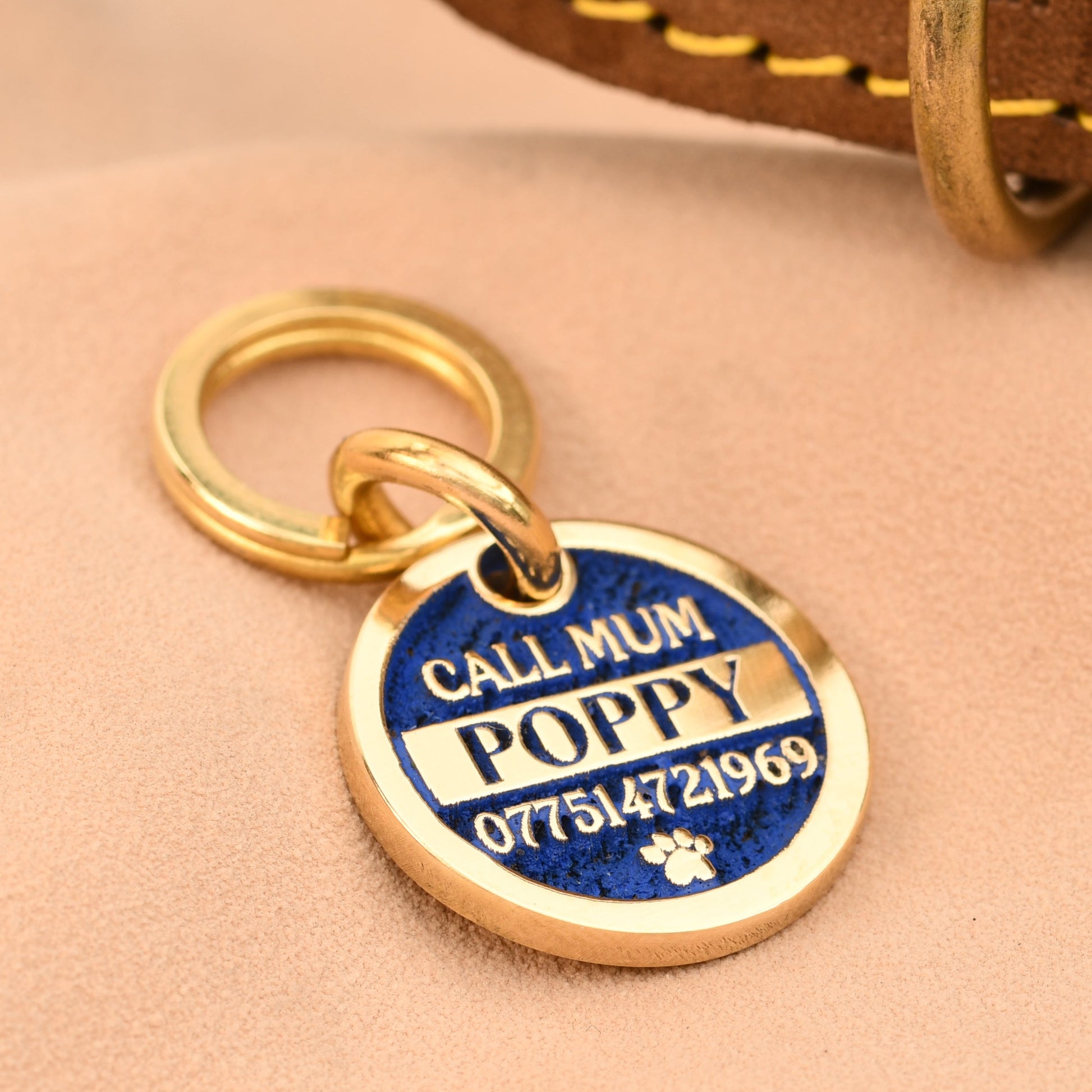 Dog tag with 'Call Mum Poppy' on a leather collar
